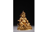 A GILT BRONZE FIGURE OF SEATED JAMBHALA