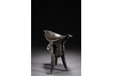 A CHINESE BRONZE JUE VESSEL