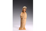 A CHINESE POTTERY FIGURE OF STANDING COURT LADY