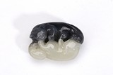 A WHITE AND BLACK JADE CARVING OF TWO CATS