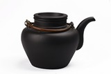 A BLACK YIXING TEAPOT AND COVER