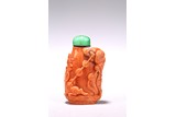 A CHINESE RED CORAL 'LIUHAN AND GOLDEN TOAD' SNUFF BOTTLE