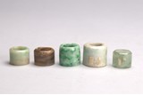 FIVE JADE AND JADEITE ARCHER'S RINGS