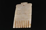 A CHINESE 'MYTHICAL BEAST' WHITE JADE COMB 