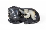A BLACK AND WHITE JADE 'BOY ON BUFFALO' CARVING 