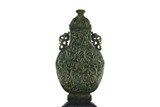A LARGE GREEN JADE 'EIGHT EMBLEMS' VASE AND COVER