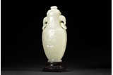 A WHITE JADE 'TAOTIE' ELEPHANT HANDLE VASE AND COVER