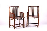 A PAIR OF HONGMU HARDWOOD SPINDLE BACK ARMCHAIRS