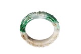 A NATURAL JADEITE CARVED BANGLE