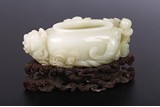 A CHINESE WHITE JADE 'BOY AND DRAGONFISH' WASHER