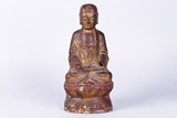 A GILT AND LACQUERED WOOD CARVED SEATED BUDDHA