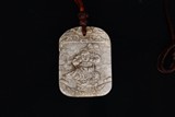 A CHINESE CALCIFIED JADE 'BOY' PLAQUE