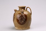 A CHINESE BROWN GLAZED EWER