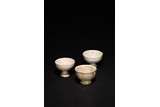 A GROUP OF THREE WHITE GLAZED CUPS