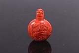 A RED CORAL CARVED SNUFF BOTTLE