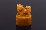 A YELLOW SOAPSTONE CARVED LION FINIAL SEAL