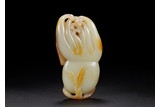 A CHINESE WHITE AND RUSSET JADE FINGER CITRON